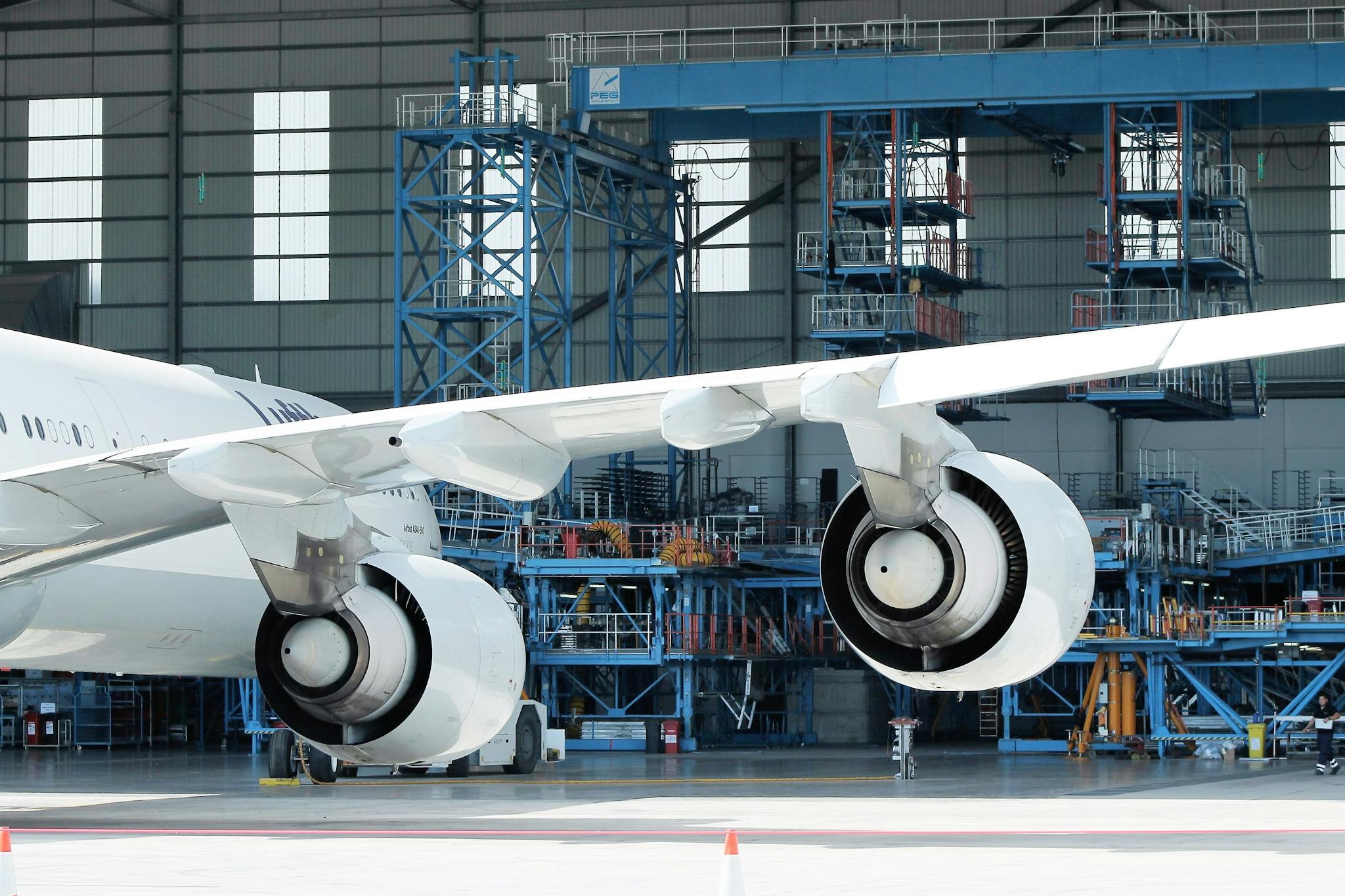 Low angle of engines and wing of modern aircraft in docking station on sunny day